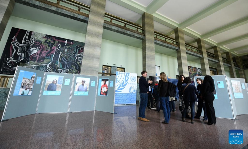 People visit the photo exhibition Shared Lives, Shared Future at the Palais des Nations in Geneva, Switzerland, Oct. 24, 2025. A photo exhibition titled Shared Lives, Shared Future commemorating the 80th anniversary of the United Nations was opened here at the Palais des Nations on Friday, which coincided with United Nations Day. The exhibition presented 27 stories showing the United Nations made a difference in people's daily lives, from advancing peace and security to providing humanitarian aid. (Photo: Xinhua)