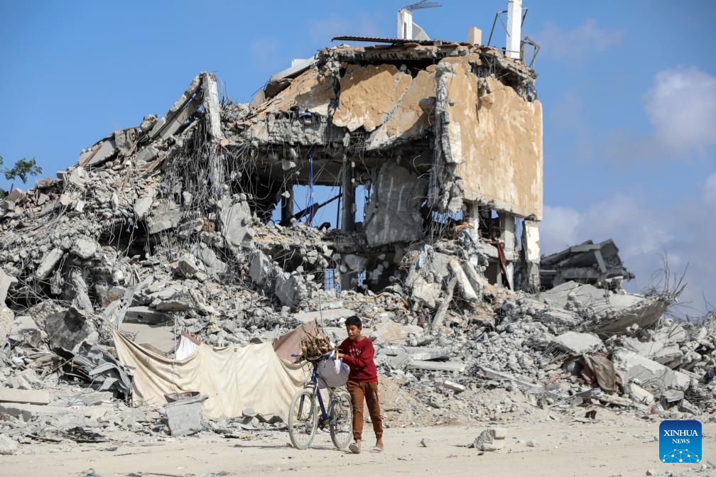A Palestinian child walks on a street of destroyed buildings in Jabalia, northern Gaza Strip, Oct. 24, 2025. The United Nations estimates that approximately 92 percent of all residential buildings in Gaza -- around 436,000 homes -- have been damaged or destroyed since the start of the conflict. According to the UN, at least 1.9 million people across the Gaza Strip have been displaced during the war. (Photo: Xinhua)