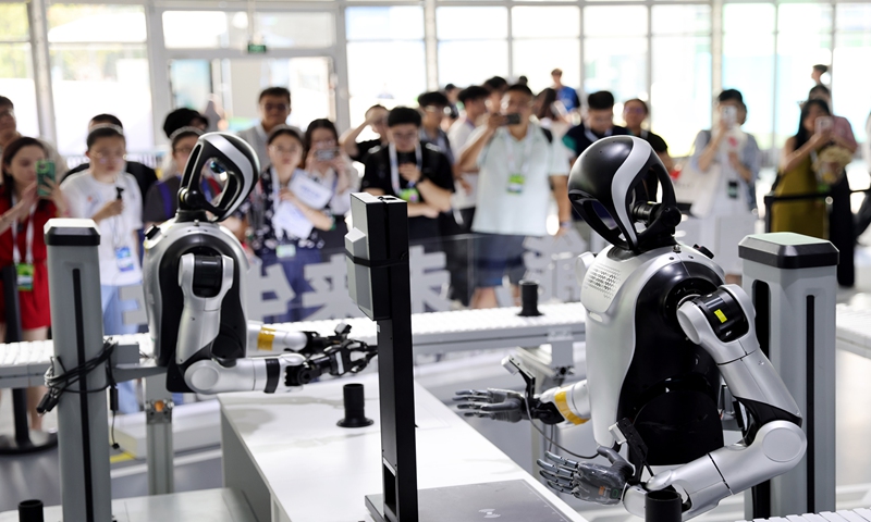 Two humanoid robots perform an interactive demonstration at Apsara Conference 2025 in Hangzhou, East China's Zhejiang Province, on September 23, 2025. Photo: VCG