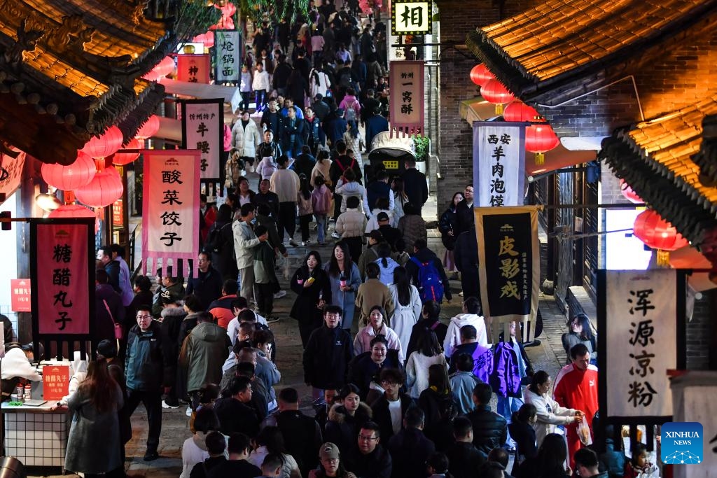Tourists visit the Xinzhou ancient city in Xinzhou, north China's Shanxi Province, on Oct. 25, 2025. Leisure tourism in Xinzhou ancient city remains booming in late autumn. Tourism activities such as bathing in hot springs, taking photos in ancient costumes, and watching intangible cultural heritage performances have attracted many tourists to visit the ancient city for a few days, to deeply immerse themselves in the unique charm of traditional culture. (Photo: Xinhua)