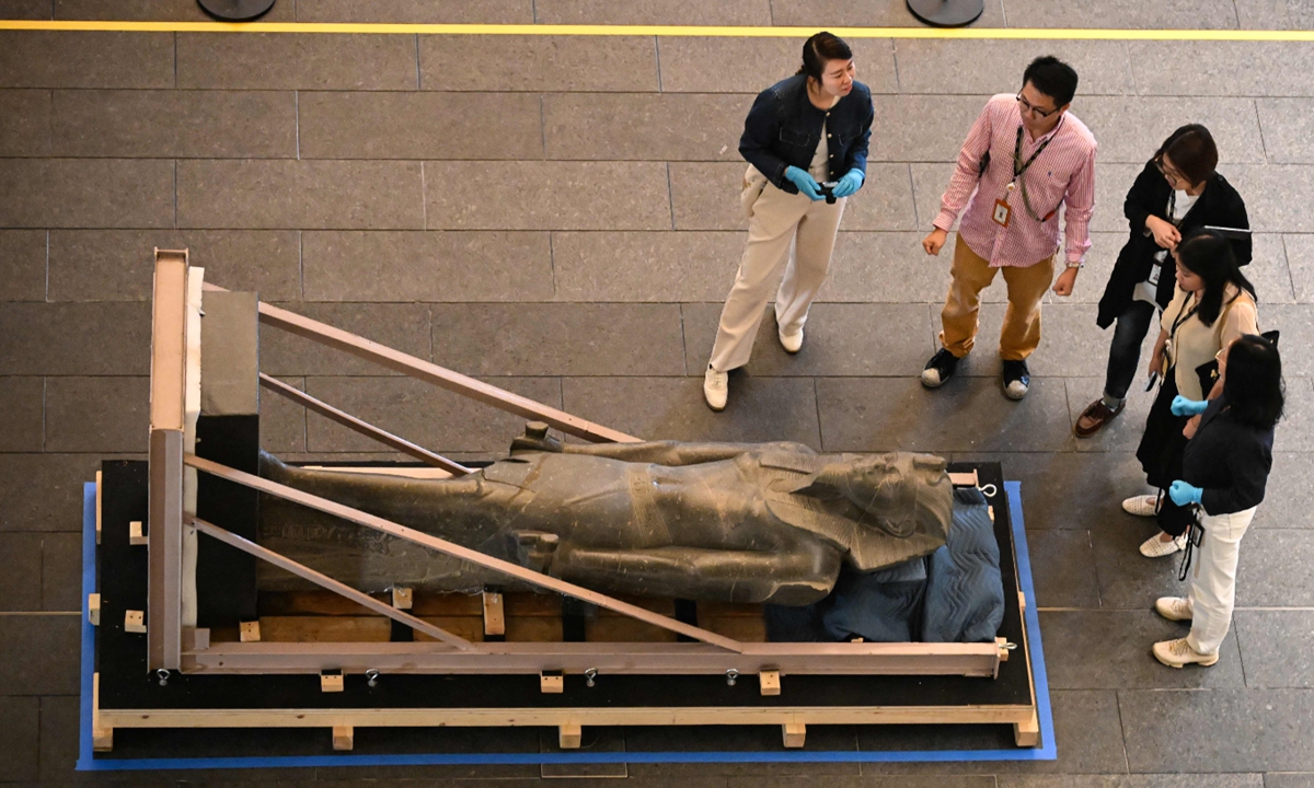 Experts look at the 2.4-meter-tall Egyptian statue of Merneptah, the fourth pharaoh of the Nineteenth Dynasty of Ancient Egypt, at the Hong Kong Palace Museum in Hong Kong, China, on October 28, 2025. In a collaboration between the Hong Kong Palace Museum and the Supreme Council of Antiquities of Egypt, the exhibition Ancient Egypt Unveiled: Treasures from Egyptian Museums will be held in the city from November 20, 2025 to August 31, 2026. Photo: VCG