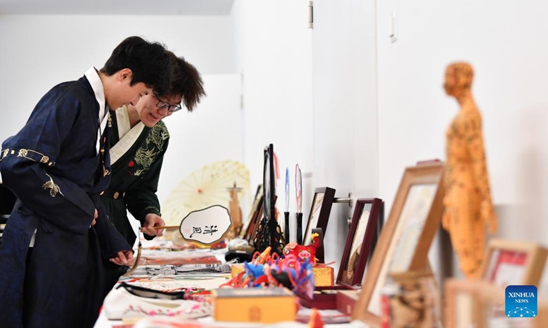 People in Chinese folk costumes view exhibits at a cultural event featuring Chinese intangible cultural heritage in Wallisellen, Zurich, Switzerland, Oct. 26, 2025. A cultural event featuring Chinese intangible cultural heritage and a photo exhibition on Wang Yangming, a Chinese philosopher and educator of Ming Dynasty (1368-1644), opened here on Sunday. (Photo: Xinhua)