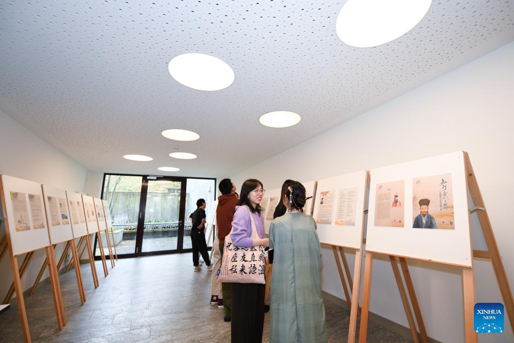 People visit a photo exhibition during a cultural event in Wallisellen, Zurich, Switzerland, Oct. 26, 2025. A cultural event featuring Chinese intangible cultural heritage and a photo exhibition on Wang Yangming, a Chinese philosopher and educator of Ming Dynasty (1368-1644), opened here on Sunday. (Photo: Xinhua)