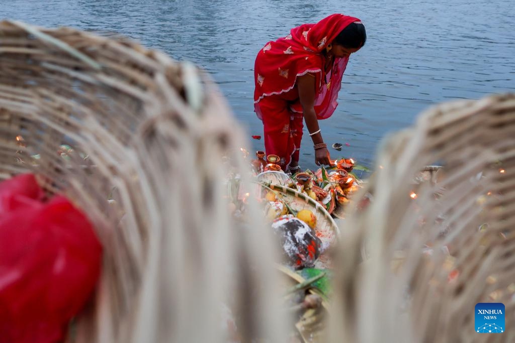 A Hindu devotee offers prayers to the setting sun on the occasion of the Chhath festival in Kathmandu, Nepal, Oct. 27, 2025. The Chhath festival is dedicated to the sun with Hindu devotees making offerings to the setting and rising sun. (Photo: Xinhua)