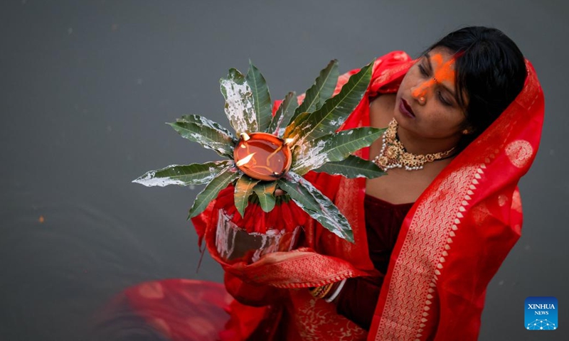 A Hindu devotee offers prayers to the setting sun on the occasion of the Chhath festival in Kathmandu, Nepal, Oct. 27, 2025. The Chhath festival is dedicated to the sun with Hindu devotees making offerings to the setting and rising sun. (Photo: Xinhua)