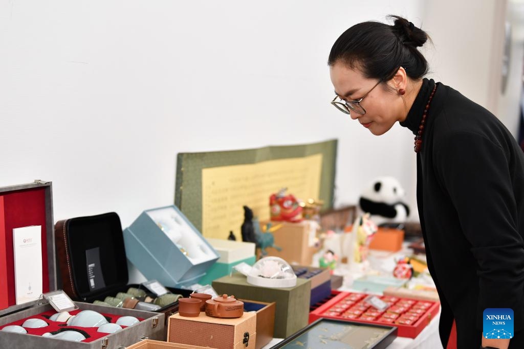 A woman views tea pots at a cultural event featuring Chinese intangible cultural heritage in Wallisellen, Zurich, Switzerland, Oct. 26, 2025. A cultural event featuring Chinese intangible cultural heritage and a photo exhibition on Wang Yangming, a Chinese philosopher and educator of Ming Dynasty (1368-1644), opened here on Sunday. (Photo: Xinhua)