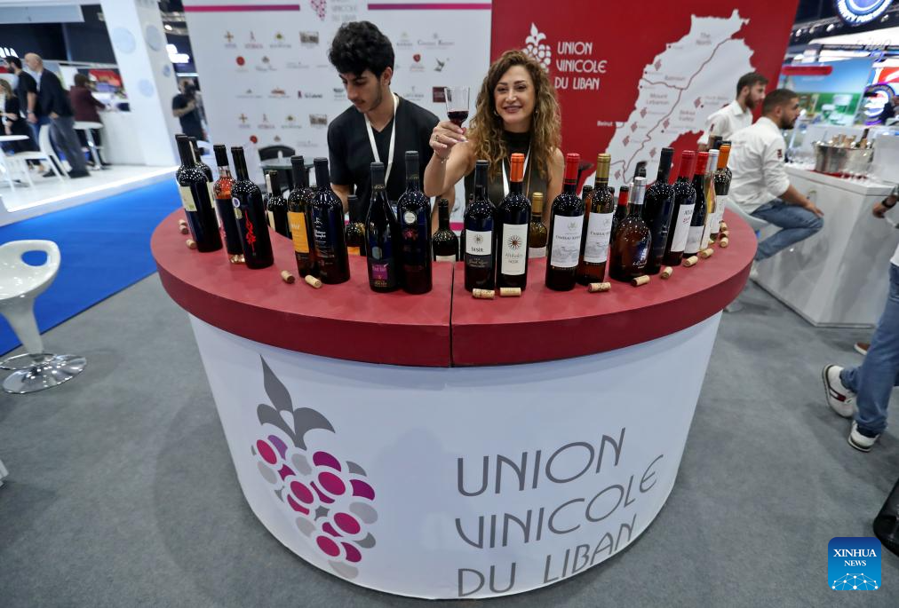 This photo taken on Oct. 29, 2025 shows an exhibitor displaying Lebanese products at the Lebanese Industry Expo 2025 in Beirut, Lebanon. The expo, which takes place in Beirut from Oct. 29 to Nov. 1, aims to bring together leaders, innovators, and stakeholders from across Lebanon's industrial sector to showcase products, exchange ideas, and explore new opportunities. (Xinhua/Bilal Jawich)