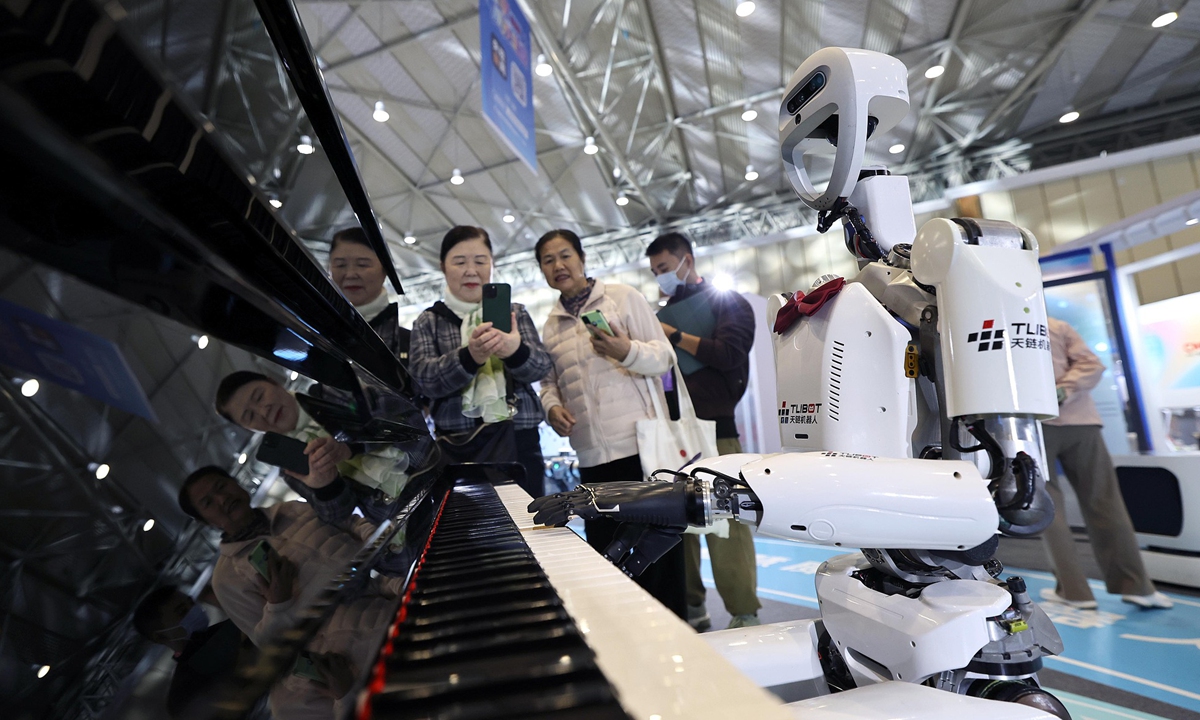 A humanoid robot plays the piano at a local smart health and elderly care robot exhibition held in Chengdu, Southwest China's Sichuan Province, on October 29, 2025. The exhibition integrated 175 smart health and elderly care robot products into real-life scenarios, showcasing a new vision of future life brought by robots. Photo: VCG