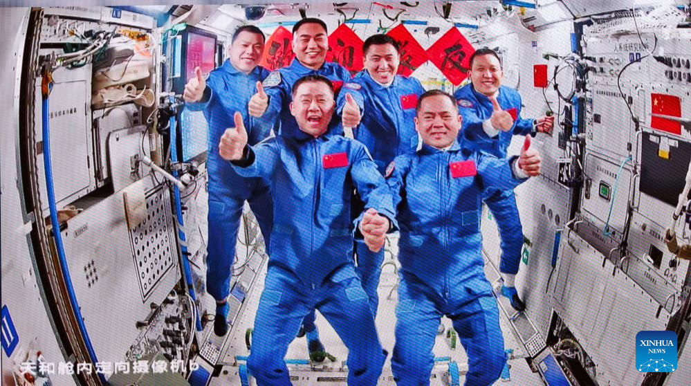 This image captured at Beijing Aerospace Control Center on Nov. 1, 2025 shows a group picture of the crew of Shenzhou-20 and Shenzhou-21 spaceships. The three astronauts aboard China's Shenzhou-21 spaceship have entered the country's space station and met with another astronaut trio early Saturday morning, starting a new round of in-orbit crew handover. The Shenzhou-20 crew opened the hatch at 4:58 a.m. (Beijing Time) and greeted the new arrivals, according to the China Manned Space Agency (CMSA). The six crew members then took group pictures for the seventh space get-together in China's aerospace history. They will live and work together for about five days to complete planned tasks and handover work, the CMSA said. (Xinhua/Jin Liwang)