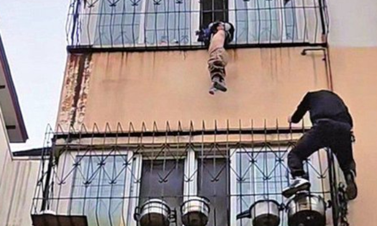In Kaifeng city, Central China's Henan Province, a delivery rider climbed an exterior wall to rescue a boy dangling from a fourth-floor window guard, drawing millions of likes online, according to multiple media reports. Photo: web