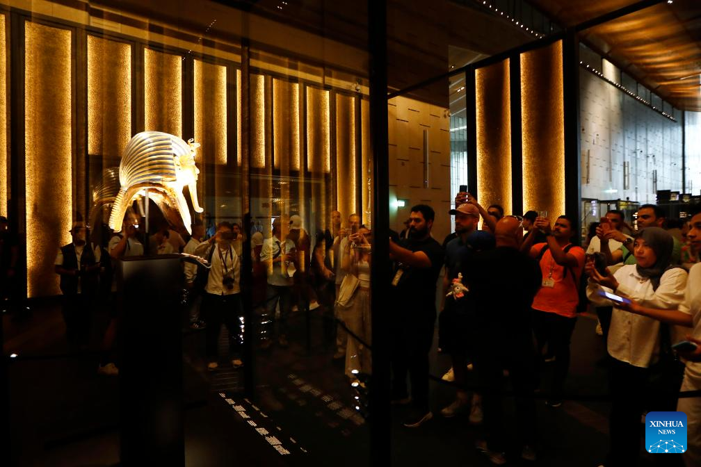 Tourists take photos of the golden mask at the King Tutankhamun exhibition hall of the Grand Egyptian Museum in Giza, Egypt, on Nov. 4, 2025. The Grand Egyptian Museum (GEM) , the world's largest museum dedicated to a single civilization, opened to the public on Tuesday. (Xinhua/Ahmed Gomaa)