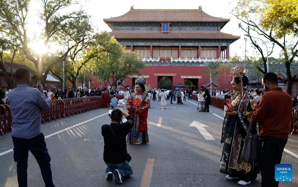 Ethiopian tourists Nuni (L front) and Betty (R front) wearing traditional Chinese costumes enjoy their photoshoot experience outside Donghua Gate,as known as East Prosperity Gate of the Palace Museum in Beijing, capital of China, Nov. 1, 2025. From January to September 2025, Beijing has received approximately 3.88 million inbound tourists, a year-on-year increase of 42.9 percent, according to Beijing Municipal Bureau of Culture and Tourism. (Photo: Xinhua)