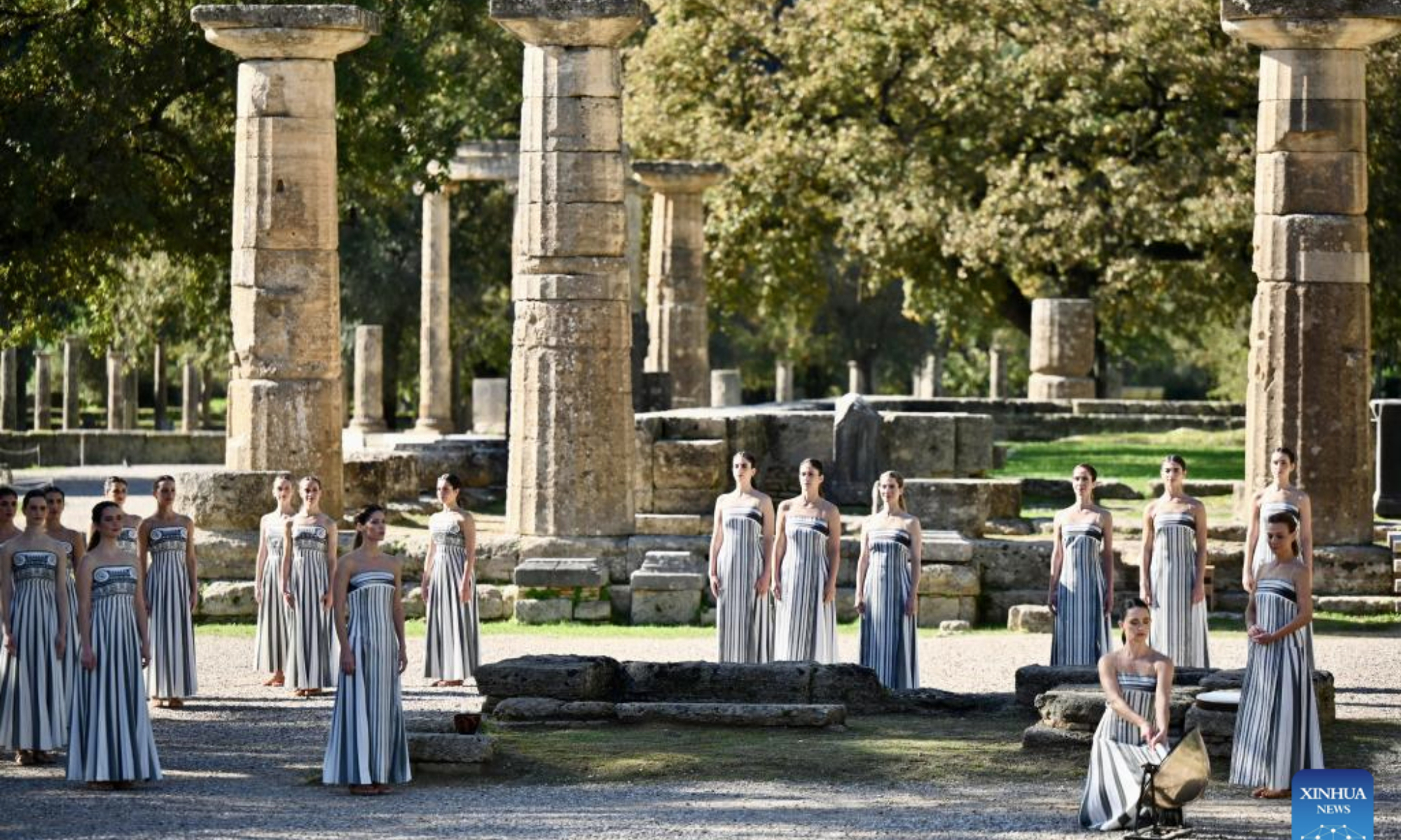Actresses playing the role of ancient priestesses perform during the dress rehearsal of the Olympic flame lighting ceremony for the Milan-Cortina 2026 Winter Olympic Games in Ancient Olympia, Greece, on Nov. 24, 2025. (Xinhua/Lyu You)