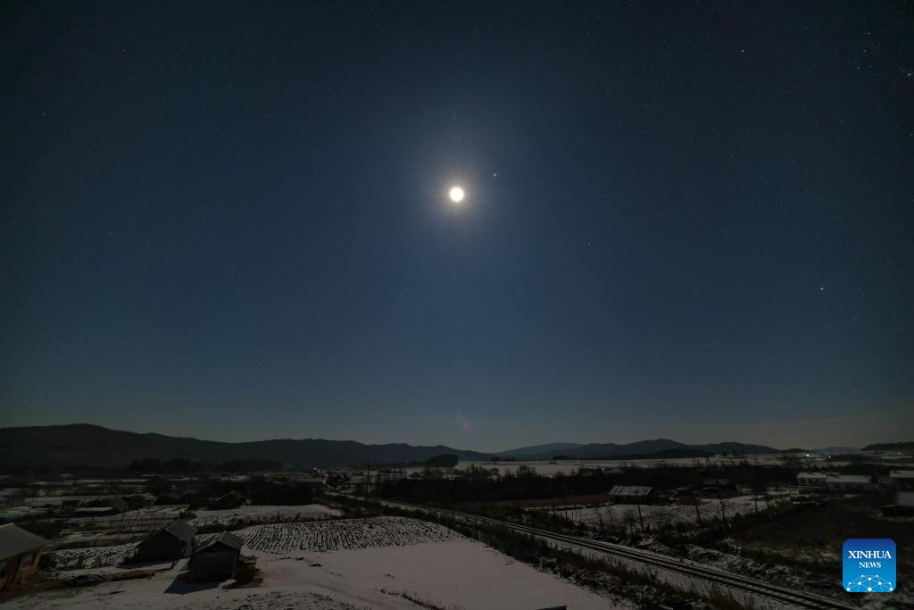 This photo taken on Nov. 11, 2025 shows a celestial scene where the moon is accompanied by Jupiter and Pollux, the brightest star in the constellation Gemini, in Yichun City, northeast China's Heilongjiang Province. (Photo by Li Jiaxing/Xinhua)