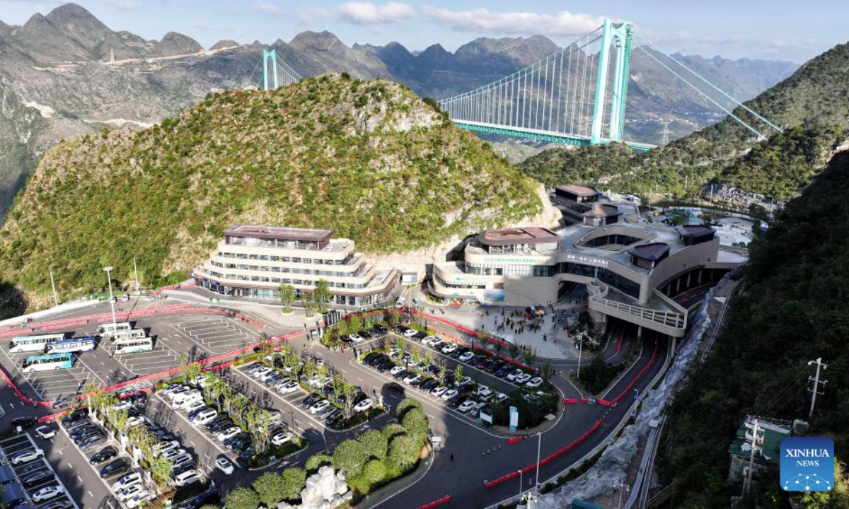 This aerial drone photo taken on Nov. 6, 2025 shows the Huajiang Grand Canyon Bridge and the nearby Yundu service area in southwest China's Guizhou Province. The Huajiang Grand Canyon Bridge, soaring 625 meters above the Beipan River in Guizhou's mountainous terrain, is the world's highest bridge. The nearby Yundu service area features a comprehensive complex that integrates bridge viewing, sports experiences and other tourism services. (Xinhua/Ou Dongqu)