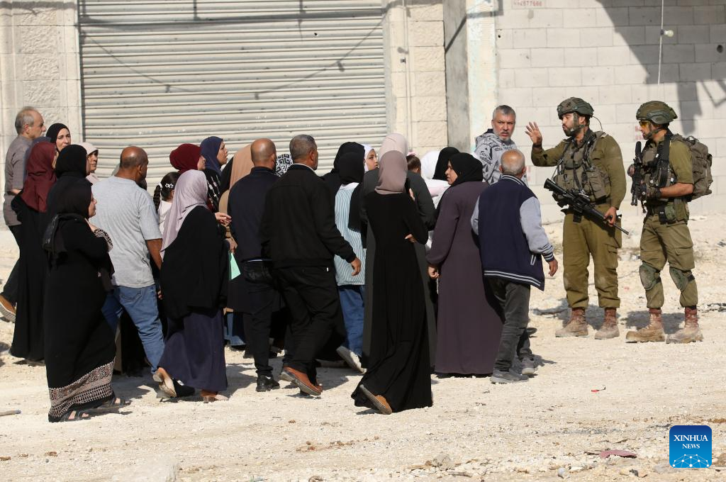 Israeli soldiers try to prevent Palestinians from reaching their houses in Nur Shams refugee camp in the West Bank city of Tulkarm, Nov. 18, 2025. Palestinians took part in a demonstration demanding the right to return to their houses at the entrance of Nur Shams refugee camp, while Israeli soldiers assaulted the crowd and forced them to leave the area. (Photo by Nidal Eshtayeh/Xinhua)