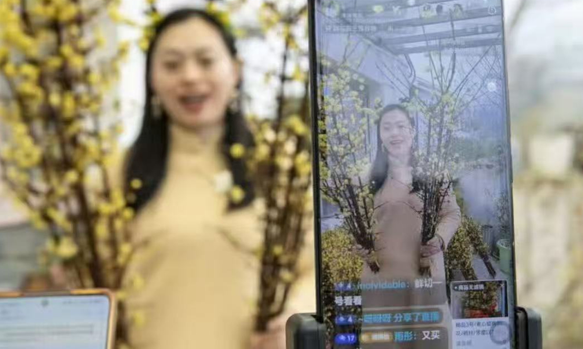 Deng Jihui sales wintersweet plants through online streaming Photo: Courtesy of Deng Jihui 