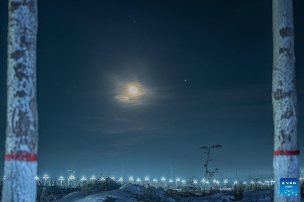 This photo taken on Nov. 10, 2025 shows a celestial scene where the moon is accompanied by Jupiter and Pollux, the brightest star in the constellation Gemini, in Bei'an City, northeast China's Heilongjiang Province. (Photo by Qian Boyu/Xinhua)