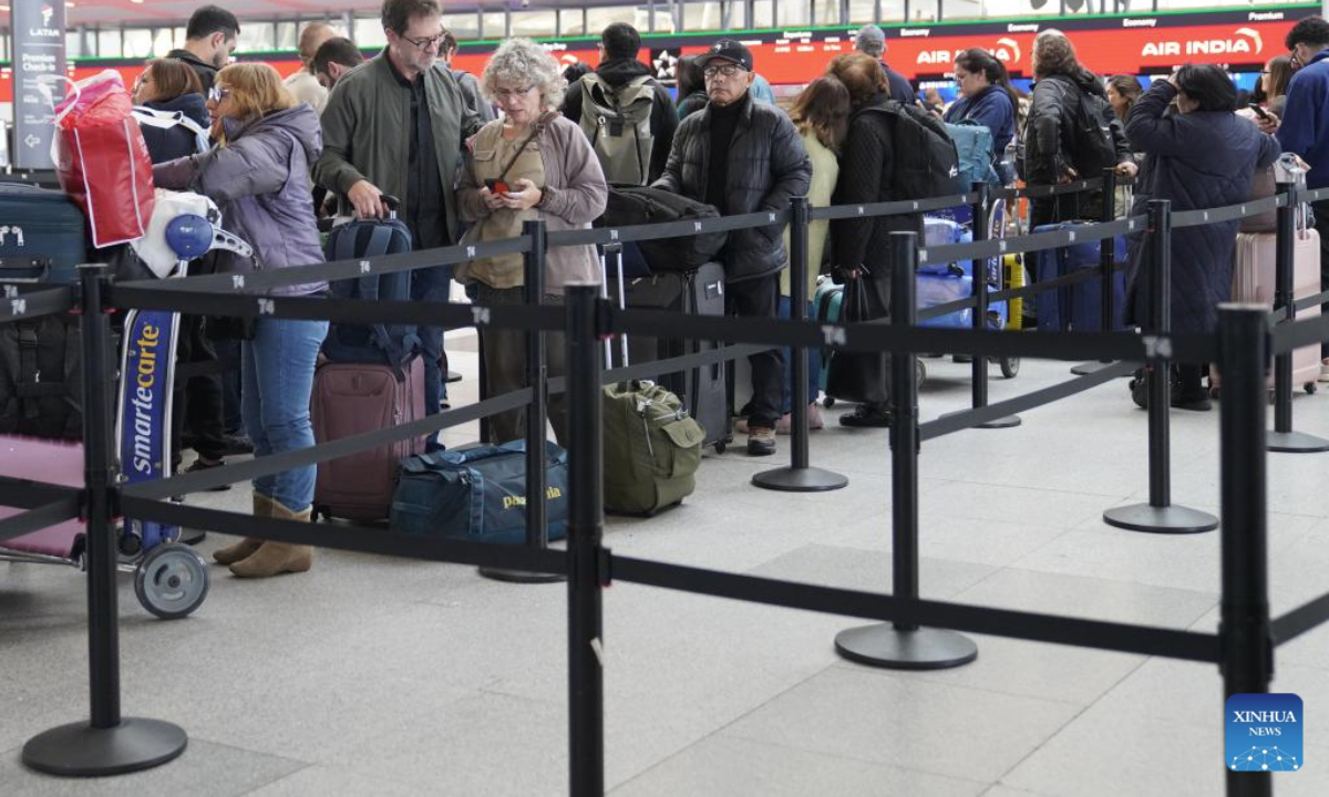 Travellers are seen at the check-in area at John F. Kennedy International Airport (JFK) in New York City, the United States, Nov. 5, 2025. As the two parties remained locked in a war of words, the impact of the record-breaking shutdown continued to spread, dealing a heavy blow to multiple areas affecting people's daily lives, including aviation safety and food assistance programs. Data from the U.S. flight-tracking website FlightAware show that thousands of flights nationwide are experiencing delays each day. (Xinhua/Zhang Fengguo)