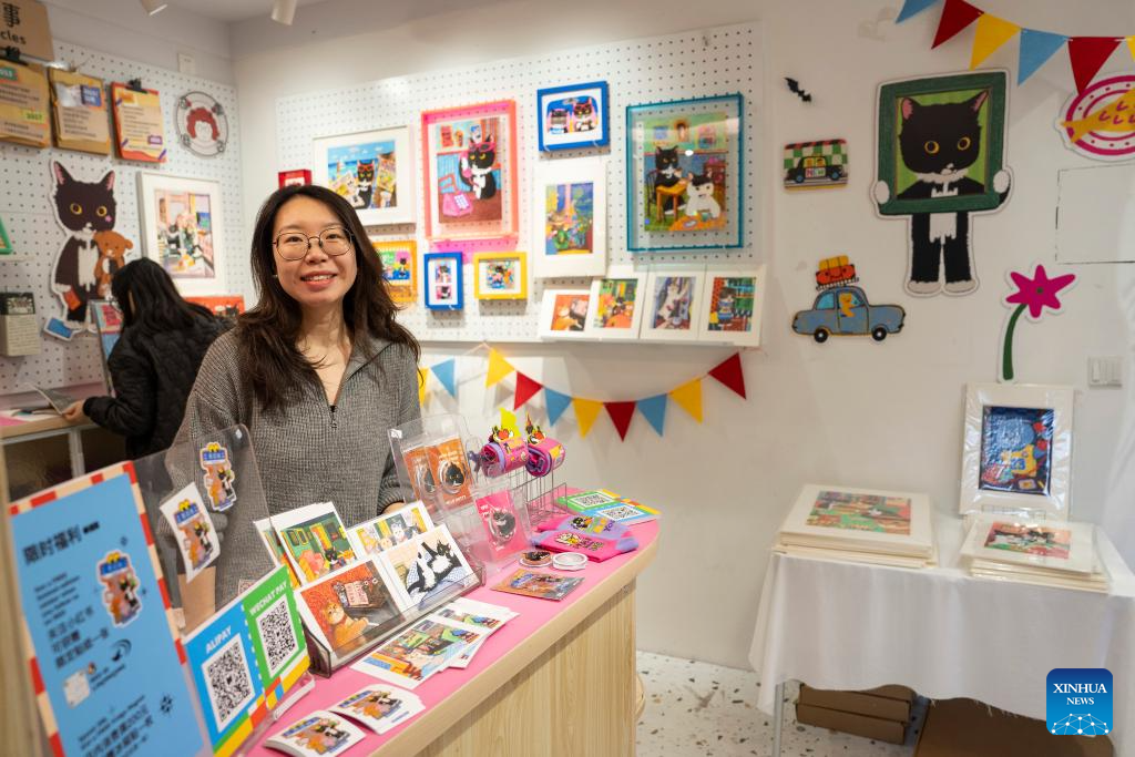 A staff member displays cultural and creative products at a store at the Yuyuan Road Historical and Cultural Block in east China's Shanghai, Nov. 12, 2025.

The Yuyuan Road Historical and Cultural Block is a well-known neighborhood in the city's downtown area. In recent years, the block has consistently pursued an urban renewal philosophy that integrates art into daily life. By introducing independent bookstores, cafes, art studios, and other establishments, it now boasts around 80 distinctive shops, making it a must-visit destination for Shanghai's artistic youth and travelers. (Xinhua/Cai Yang)