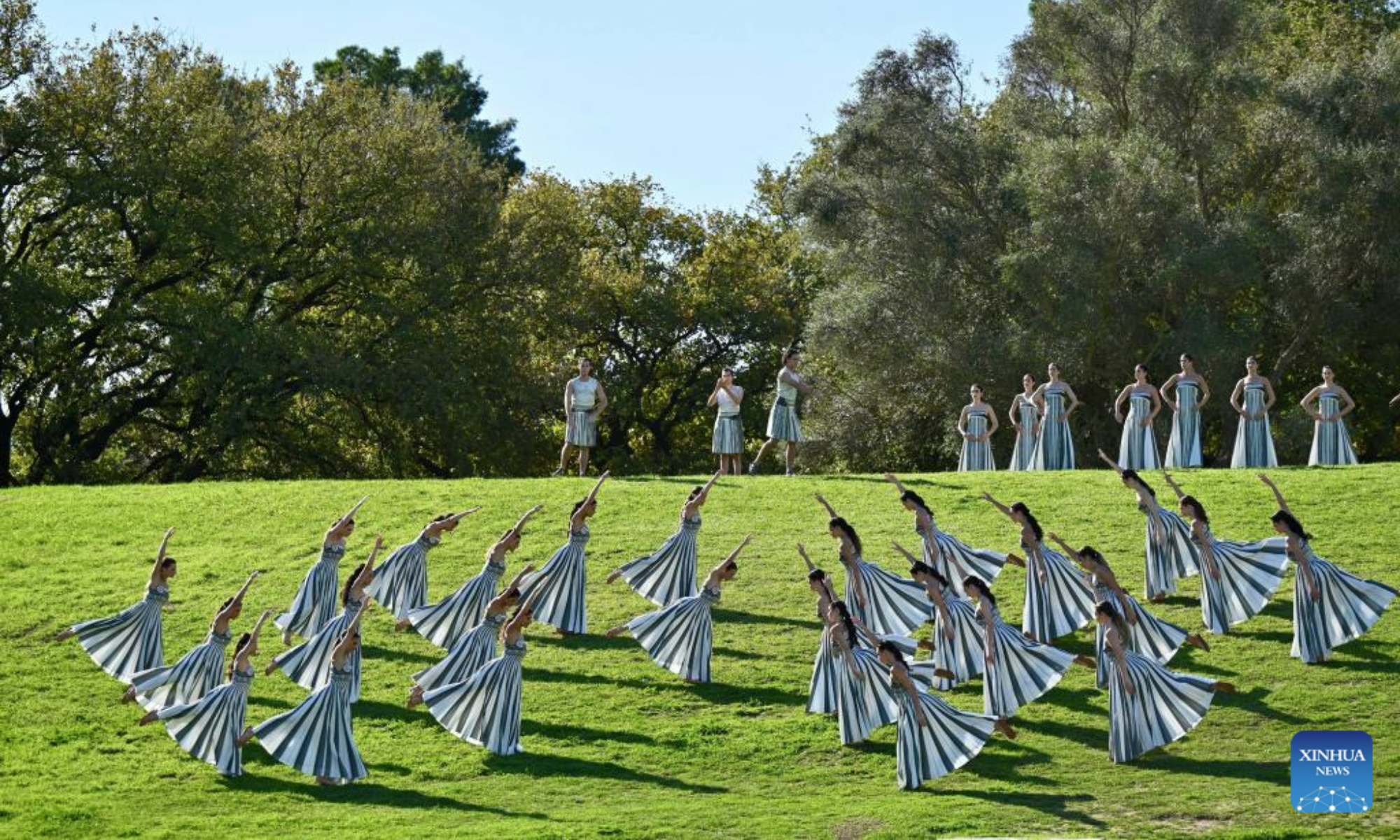 Actresses playing the role of ancient priestesses perform during the dress rehearsal of the Olympic flame lighting ceremony for the Milan-Cortina 2026 Winter Olympic Games in Ancient Olympia, Greece, on Nov. 24, 2025. (Xinhua/Lyu You)