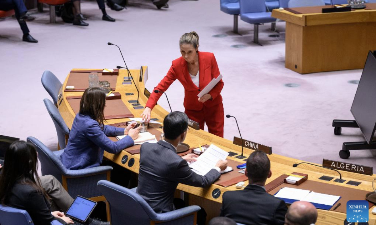 A conference officer (woman in red) hands out ballots during a Security Council meeting to elect a judge for the International Court of Justice at the UN headquarters in New York, Nov. 12, 2025. Kenyan jurist Phoebe Okowa was elected a judge of the International Court of Justice (ICJ) on Wednesday to fill the seat vacated by Somalia's Abdulqawi Yusuf, who resigned effective Sept. 30. Under the ICJ's Statute, judges are elected by secret ballot in both the Security Council and the General Assembly. (Loey Felipe/UN Photo/Handout via Xinhua)