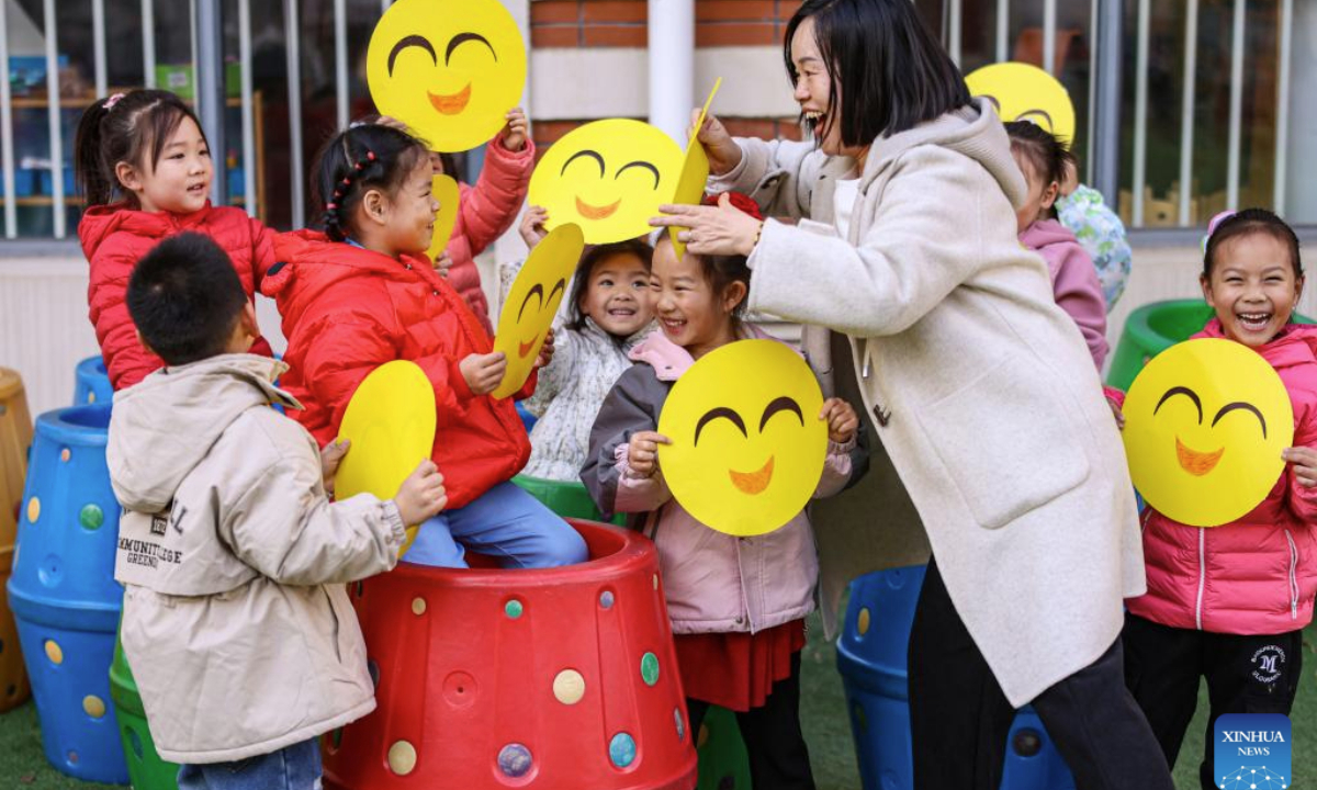 Children participate in a greeting game to celebrate the upcoming World Hello Day, which falls on Nov. 21 annually, at a kindergarten in Rongcheng, east China's Shandong Province, Nov. 20, 2025. (Photo by Li Xinjun/Xinhua)