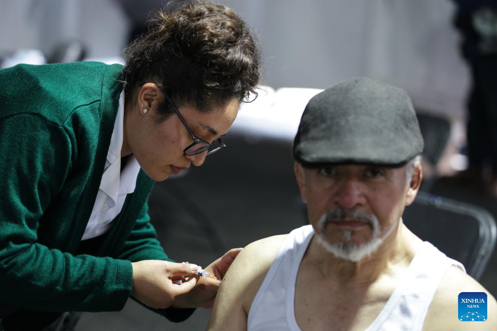 A health worker administers a vaccine to a man at a vaccination center in Mexico City, capital of Mexico, Nov. 12, 2025. Mexico City has set up a vaccination center offering influenza, COVID-19, pneumococcal and measles vaccines to the public as part of efforts to improve community immunization coverage during the winter season. (Photo by Francisco Canedo/Xinhua)