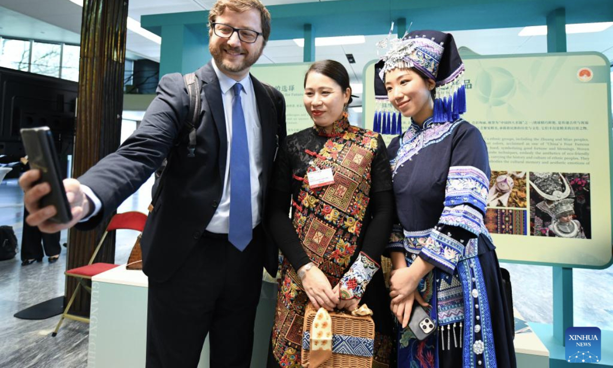 A visitor (L) takes selfies with staff members in Chinese folk costumes during China (Guangxi) Geographical Indication Products Exhibition at the World Intellectual Property Organization (WIPO) headquarters in Geneva, Switzerland, Nov. 17, 2025.
The two-day exhibition kicked off here on Monday, showcasing iconic products from south China's Guangxi Zhuang Autonomous Region, including tea, pottery and bamboo weaving craft. (Xinhua/Lian Yi)