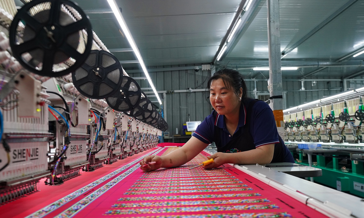 A local woman works at an embroidery workshop in Rongshui Miao Autonomous County, South China's Guangxi Zhuang Autonomous Region on November 2, 2025, as enterprises across the region race to fill orders and reach annual production targets. Photo: VCG