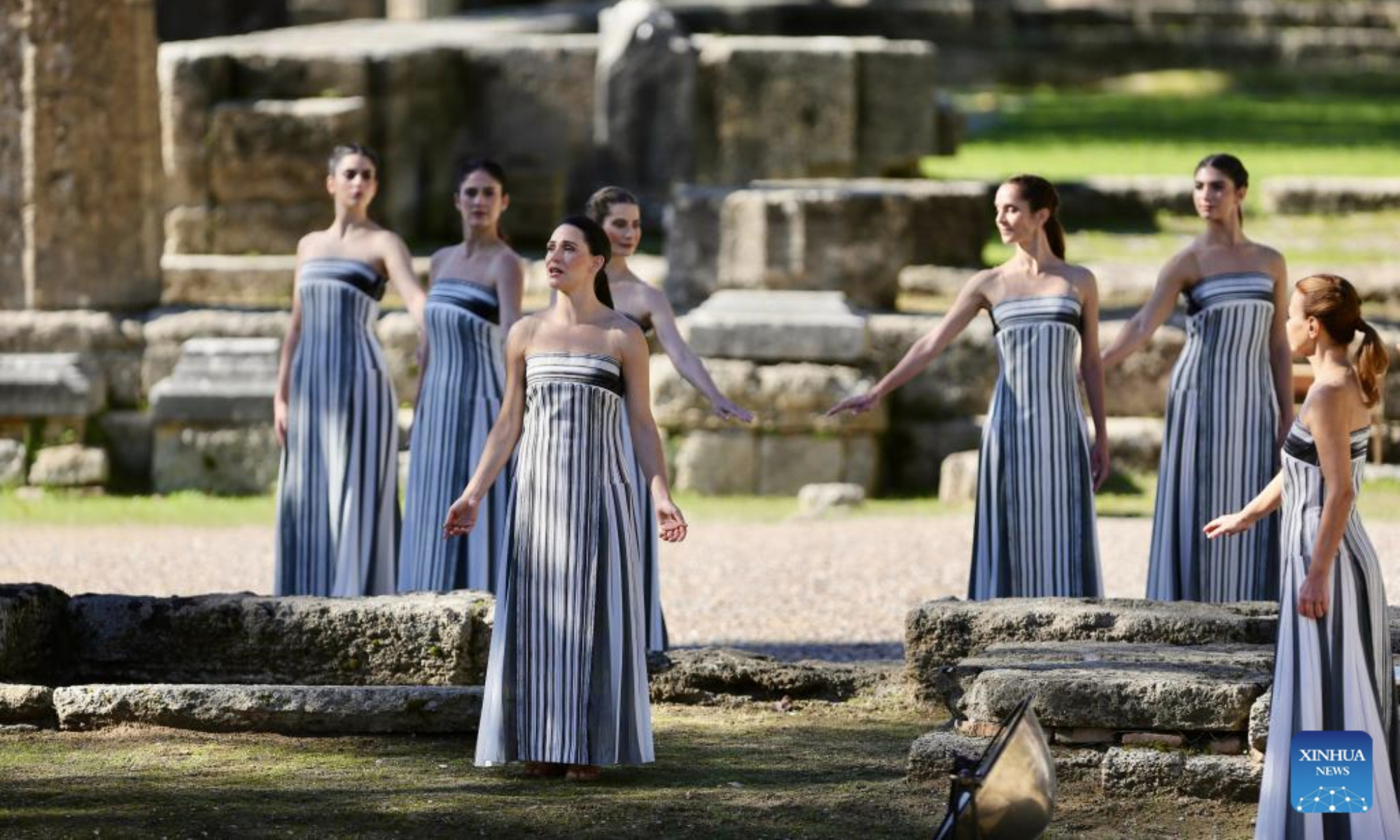 Actresses playing the role of ancient priestesses perform during the dress rehearsal of the Olympic flame lighting ceremony for the Milan-Cortina 2026 Winter Olympic Games in Ancient Olympia, Greece, on Nov. 24, 2025. (Xinhua/Lyu You)
