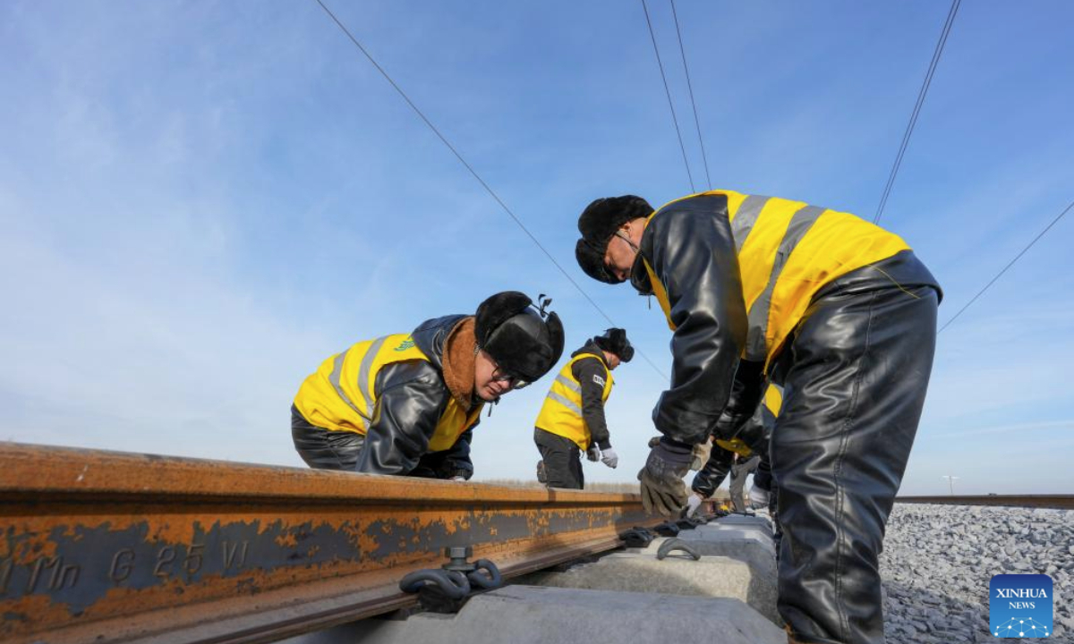 Constructors work at a construction site of the Harbin-Yichun high-speed railway in Qing'an County, northeast China's Heilongjiang Province, Nov. 25, 2025. Track-laying for the Harbin-Yichun high-speed railway completed on Tuesday. The Harbin-Yichun high-speed railway is China's northernmost high-speed railway under construction. (Xinhua/Wang Song)