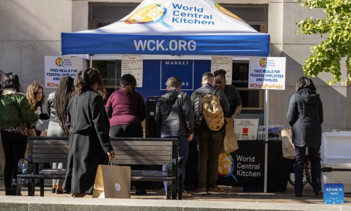 Federal employees receive free meals at a free food distribution stall in Washington, D.C., the United States, Nov. 5, 2025. On Wednesday, the U.S. federal government shutdown entered its 36th day, surpassing the previous 35-day record set during the 2018-2019 shutdown, making it the longest government shutdown in U.S. history. (Xinhua/Hu Yousong)