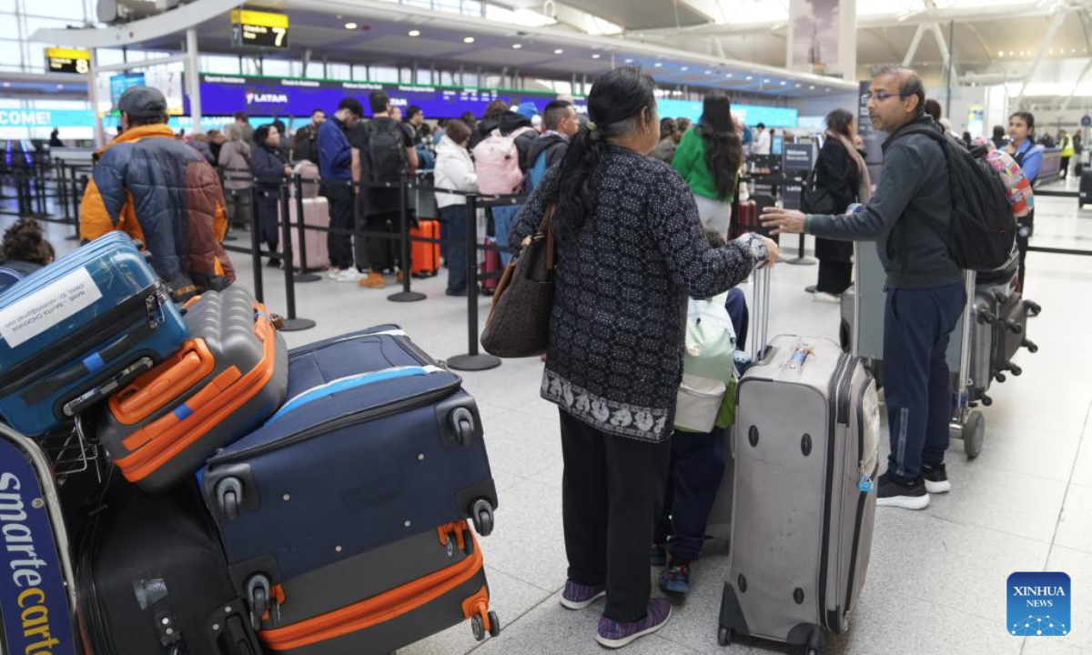Travellers are seen at the check-in area at John F. Kennedy International Airport (JFK) in New York City, the United States, Nov. 5, 2025. As the two parties remained locked in a war of words, the impact of the record-breaking shutdown continued to spread, dealing a heavy blow to multiple areas affecting people's daily lives, including aviation safety and food assistance programs. Data from the U.S. flight-tracking website FlightAware show that thousands of flights nationwide are experiencing delays each day. (Xinhua/Zhang Fengguo)