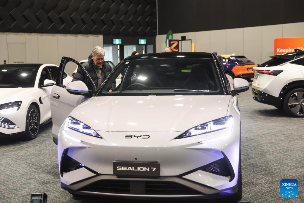 A man learns about a Chinese BYD vehicle at the Take Charge Expo in Christchurch, New Zealand, Nov. 1, 2025. The on-going expo showcases the latest in battery electric vehicles with Chinese brands drawing attention from international buyers. (Photo: Xinhua)
