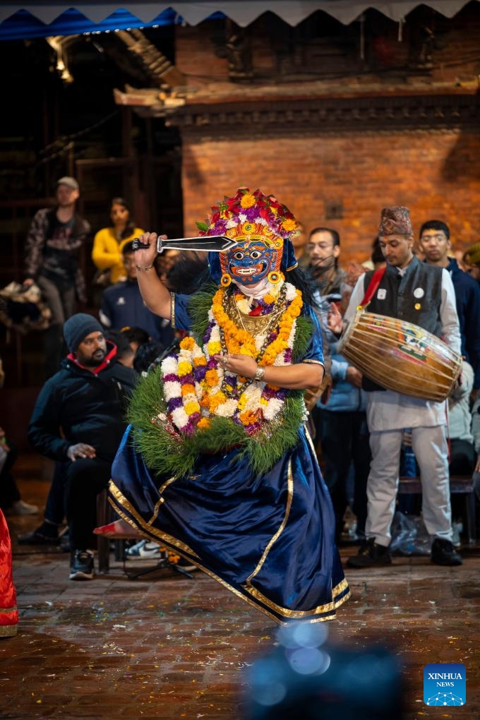 A masked dancer performs during the Kartik Naach Festival on the premises of Patan Durbar Square in Lalitpur, Nepal, Oct. 31, 2025. The Kartik Naach festival is held annually in the Hindu lunar calendar month of Kartik, showcasing traditional dance dramas based on Hindu epics. (Photo: Xinhua)