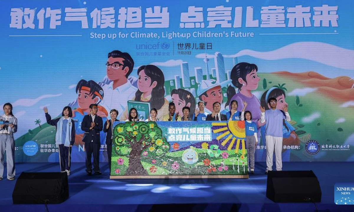 Guests and children attend an event themed Step up for Climate, Light up Children's Future, held to mark World Children's Day, in Beijing, capital of China, Nov. 20, 2025. (Xinhua/Zhang Yuwei)