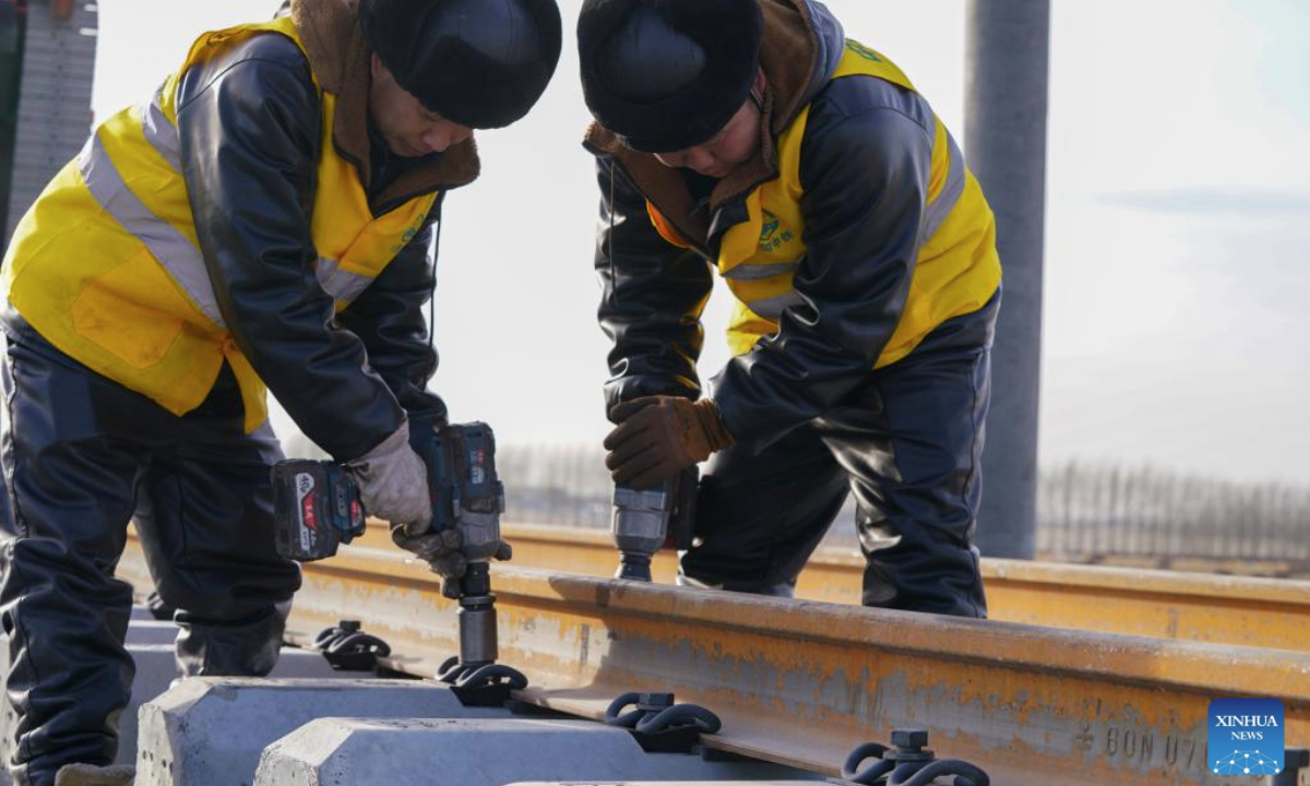 Constructors work at a construction site of the Harbin-Yichun high-speed railway in Qing'an County, northeast China's Heilongjiang Province, Nov. 25, 2025. Track-laying for the Harbin-Yichun high-speed railway completed on Tuesday. The Harbin-Yichun high-speed railway is China's northernmost high-speed railway under construction. (Xinhua/Wang Song)