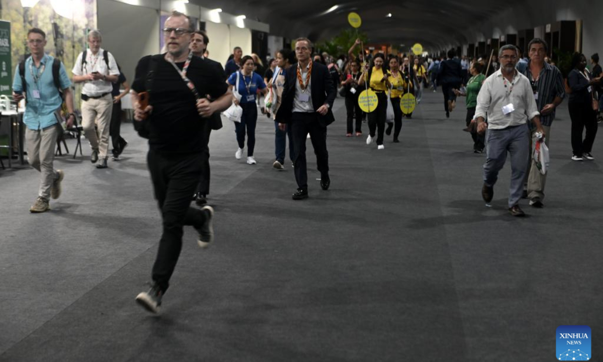 Participants evacuate the venue of the 30th United Nations Climate Change Conference (COP30) a fire borke out in Belem, Para state, Brazil, Nov. 20, 2025. A fire broke out on Thursday in a pavilion at the ongoing 30th UN Climate Change Conference in the Brazilian city of Belem, prompting evacuations by the fire department, according to local authorities. (Photo by Lucio Tavora/Xinhua)