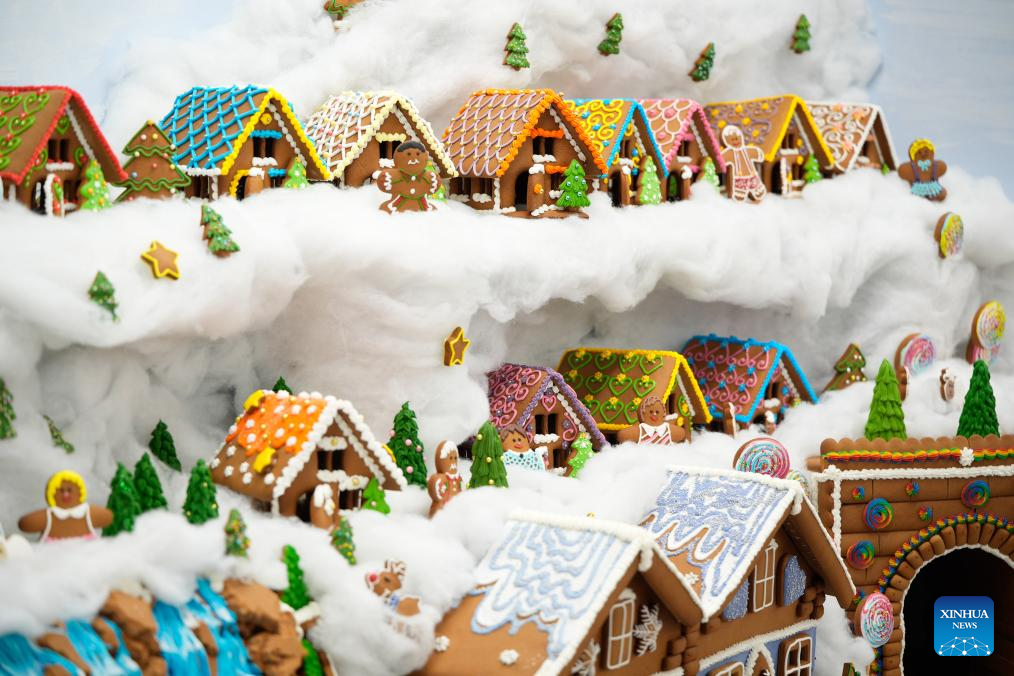 Typical Polish mountain houses made from gingerbread and coloured sugar are seen at the Gingerbread City exhibition in Warsaw, Poland, Nov. 19, 2025. (Photo by Jaap Arriens/Xinhua)