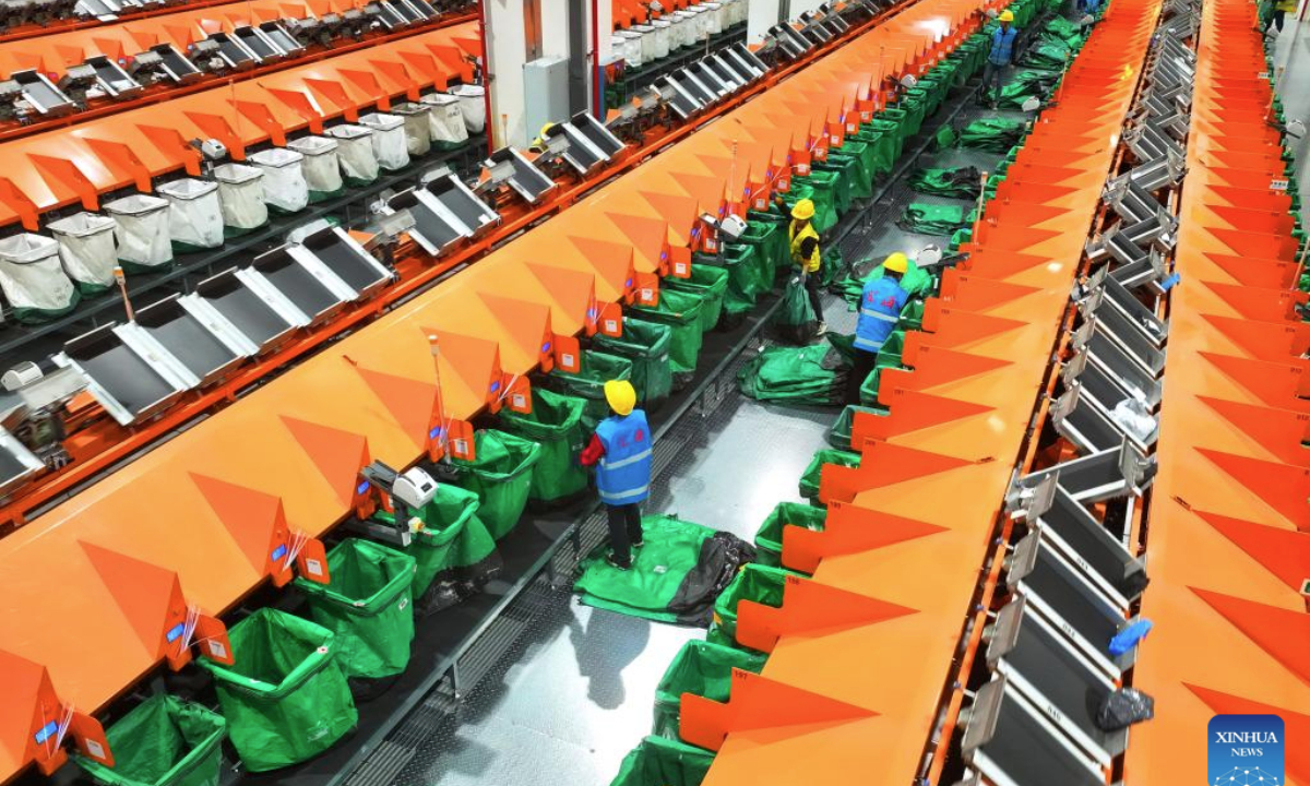 This drone photo taken on Nov. 11, 2025 shows staff members sorting parcels at a branch of China Post in Hengyang City, central China's Hunan Province. E-commerce and logistics companies across China are working at full capacity during the annual Double Eleven shopping festival. (Photo by Cao Zhengping/Xinhua)