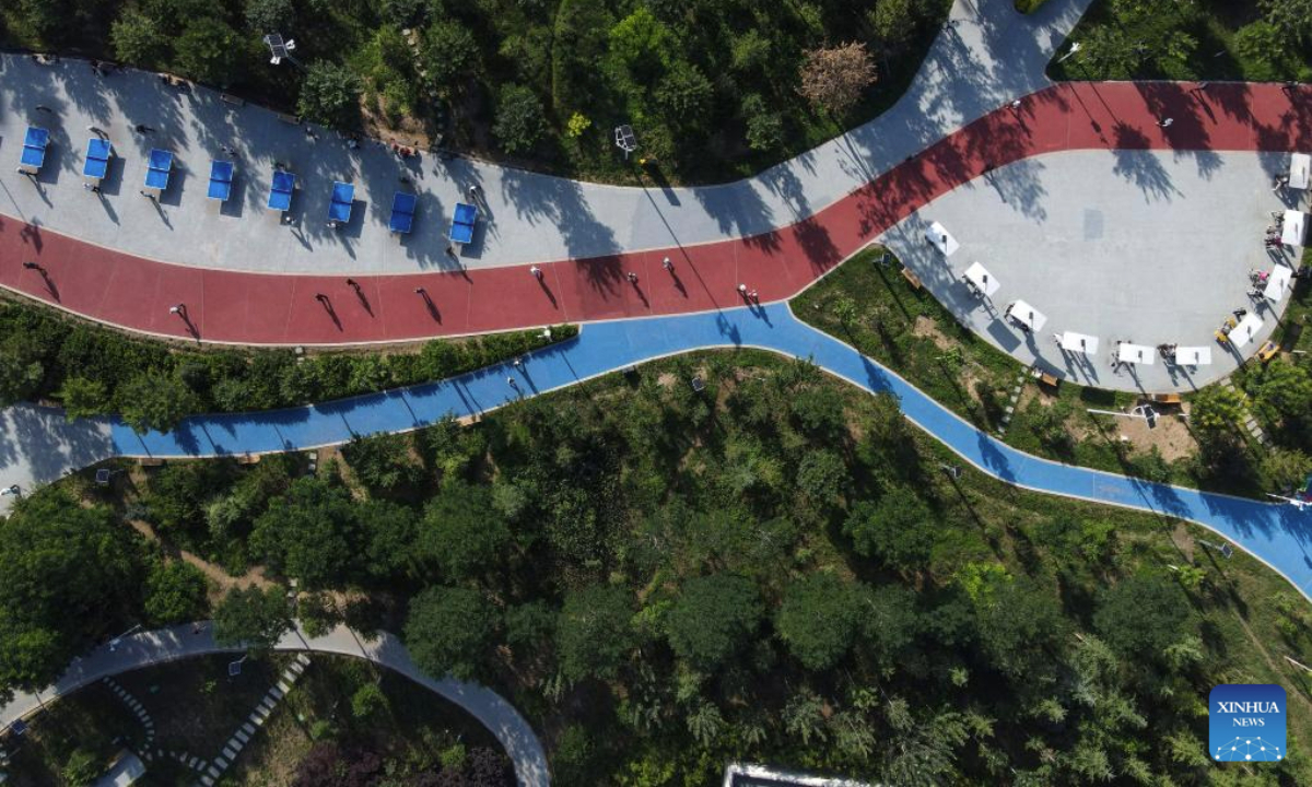 An aerial drone photo taken on July 7, 2025 shows people exercising at a park in Pingliang City, northwest China's Gansu Province.

Pingliang in Gansu Province is a key node in the Loess Plateau-Sichuan-Yunnan Ecological barrier and a major ecological zone for soil and water conservation in the hilly areas. The city has transformed traditional industries like the coal-chemical sector and developed eco-friendly projects such as solar and wind power. The forest and grassland coverage of Pingliang has reached 46.07 percent, and it has been recognized as one of the first Chinese national ecological civilization demonstration zones. (Photo by Wu Xihui/Xinhua)