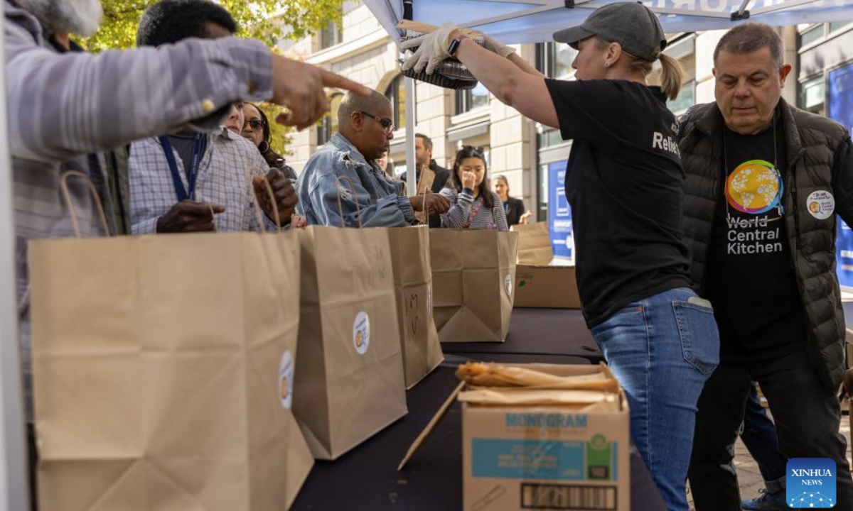 Federal employees receive free meals at a free food distribution stall in Washington, D.C., the United States, Nov. 5, 2025. On Wednesday, the U.S. federal government shutdown entered its 36th day, surpassing the previous 35-day record set during the 2018-2019 shutdown, making it the longest government shutdown in U.S. history. (Xinhua/Hu Yousong)