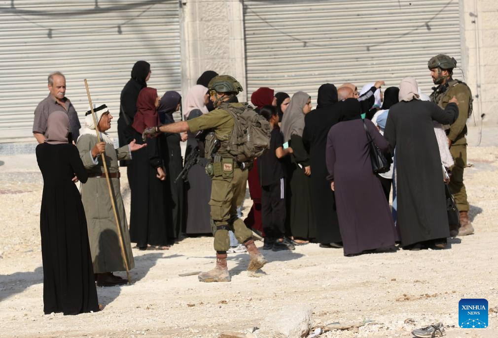 Israeli soldiers try to prevent Palestinians from reaching their houses in Nur Shams refugee camp in the West Bank city of Tulkarm, Nov. 18, 2025. Palestinians took part in a demonstration demanding the right to return to their houses at the entrance of Nur Shams refugee camp, while Israeli soldiers assaulted the crowd and forced them to leave the area. (Photo by Nidal Eshtayeh/Xinhua)