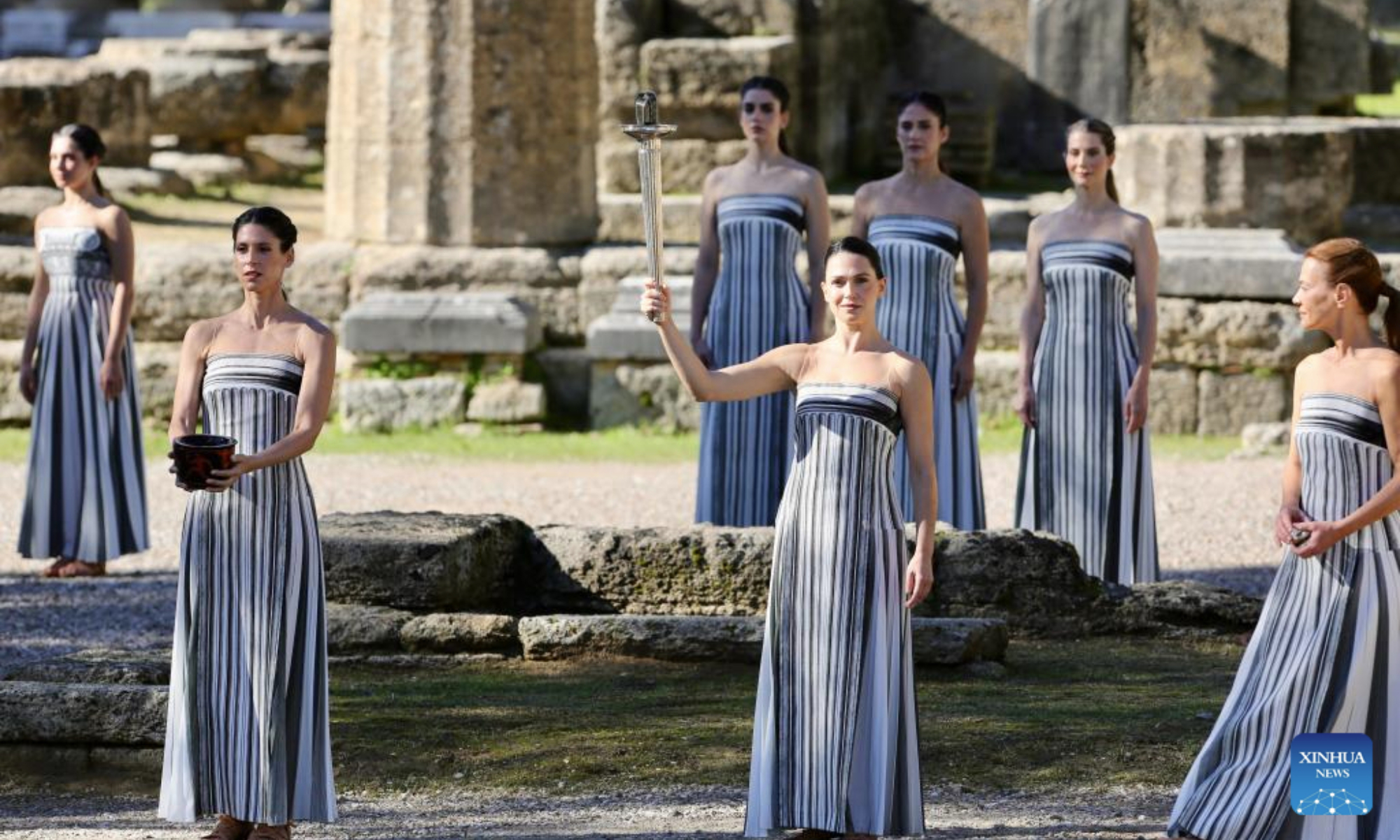 Actress Mary Mina (C front), in the role of an ancient Greek High Priestess, performs during the dress rehearsal of the Olympic flame lighting ceremony for the Milan-Cortina 2026 Winter Olympic Games in Ancient Olympia, Greece, on Nov. 24, 2025. (Xinhua/Lyu You)