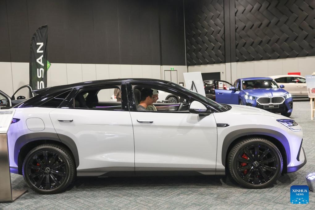 People experience a Chinese BYD vehicle at the Take Charge Expo in Christchurch, New Zealand, Nov. 1, 2025. The on-going expo showcases the latest in battery electric vehicles with Chinese brands drawing attention from international buyers. (Photo: Xinhua)