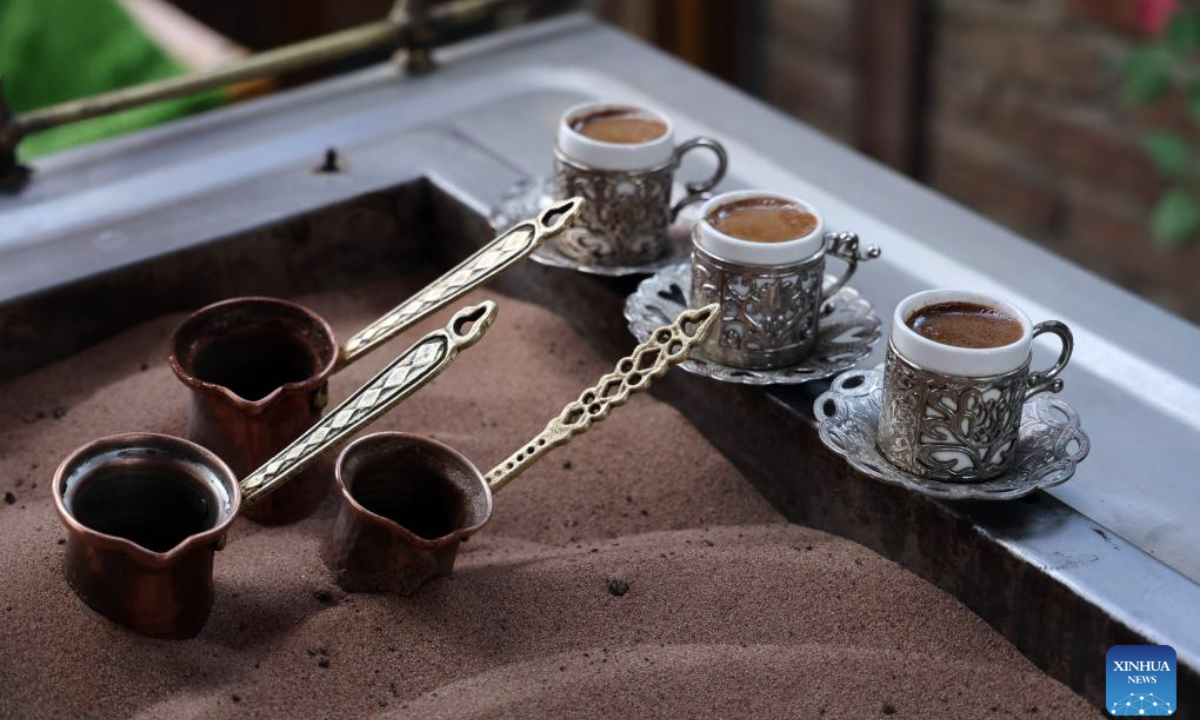 This photo taken on Nov. 12, 2025 shows the Turkish coffee being brewed with hot sand in Ankara, Türkiye. The brewing process of Turkish sand coffee involves little coffee pots nestling in a bed of hot sand. (Mustafa Kaya/Handout via Xinhua)