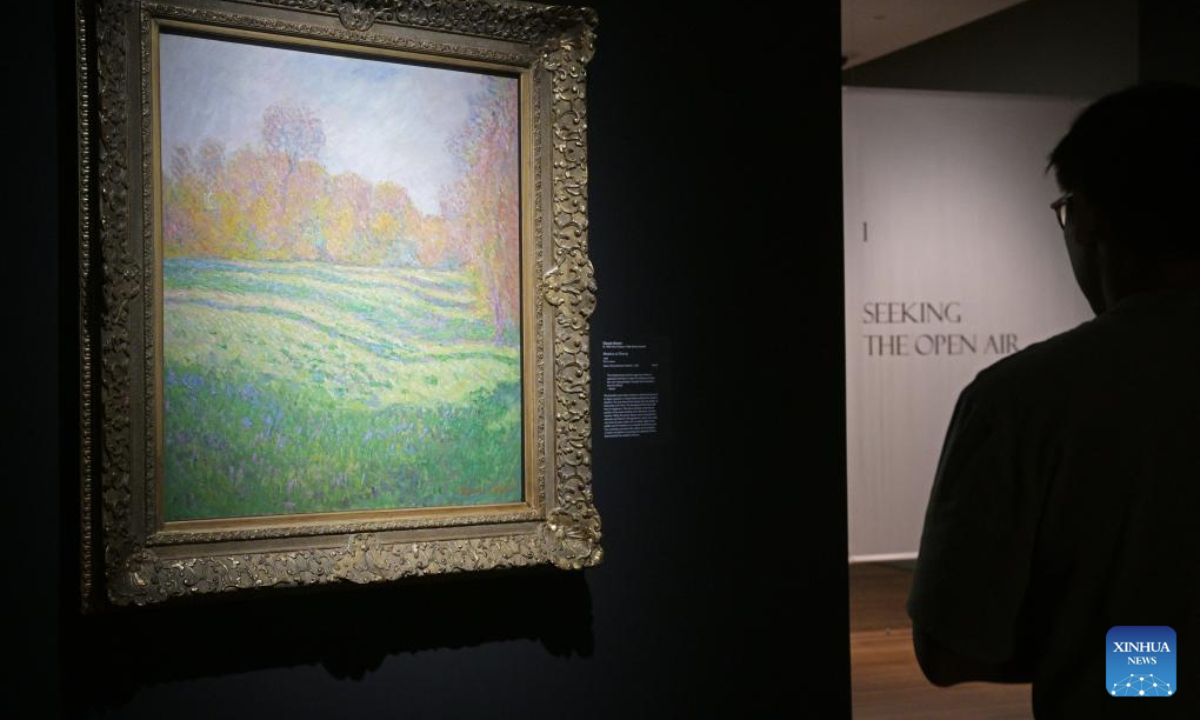 A journalist attends the media preview of Into the Modern: Impressionism from the Museum of Fine Arts, Boston art exhibition held at the National Gallery Singapore in Singapore, on Nov 12, 2025. The exhibition will open on Nov. 14, featuring artworks by artists like Claude Monet, Pierre-Auguste Renoir and Edgar Degas. (Photo by Then Chih Wey/Xinhua)