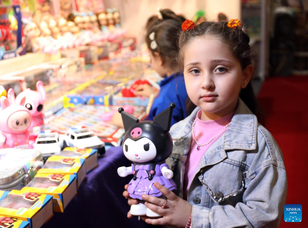 A girl holds a toy during Iraq International Children's Festival in Baghdad, Iraq, Nov. 19, 2025. The forth edition of the Iraq International Children's Festival kicked off on Wednesday and will last 10 days. (Xinhua/Khalil Dawood)