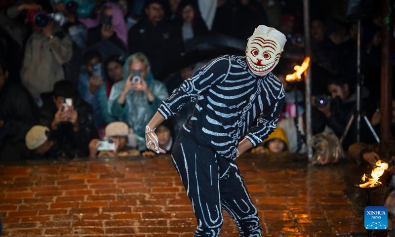 A masked dancer performs during the Kartik Naach Festival on the premises of Patan Durbar Square in Lalitpur, Nepal, Oct. 31, 2025. The Kartik Naach festival is held annually in the Hindu lunar calendar month of Kartik, showcasing traditional dance dramas based on Hindu epics. (Photo: Xinhua)